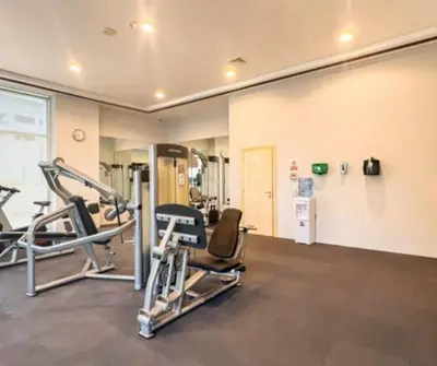 a gym with treadmills and chairs in a room at Ferrari Inspired Modern 3BHK with maids room and Full Sea View in Dubai