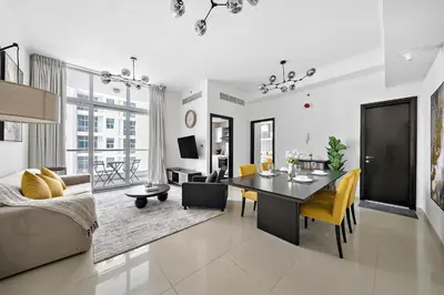 a living room with a dining room table and a couch at Newly-furnished 1BR at DEC Tower 2 in Dubai