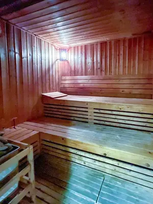 a large wooden sauna with a bench in it at Lovely Studio at The Arch Tower JLT in Dubai