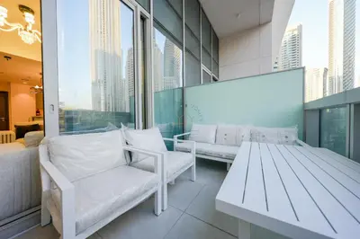 a room with two white benches and a large window at Forte Luxe - Stylish 2BR Downtown Escape in Dubai