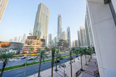 a view of a city with palm trees and buildings at Forte Luxe - Stylish 2BR Downtown Escape in Dubai
