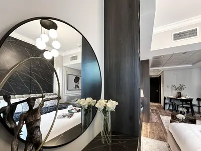 a room with a mirror and a bed at Trophy- Radiant Retreat in JLT With Skyline View in Dubai