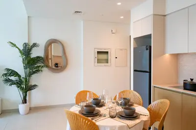 a kitchen and dining room with a table and chairs at Cozy 1-BR in the heart of Dubai with skyline views in Dubai