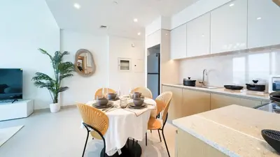 a kitchen and dining room with a table and chairs at Cozy 1-BR in the heart of Dubai with skyline views in Dubai