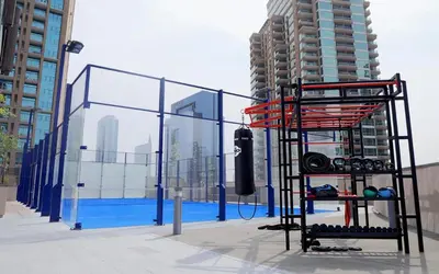 a fence next to a pool in a city at 3BR Full Marina View for 8 Near The Metro! in Dubai