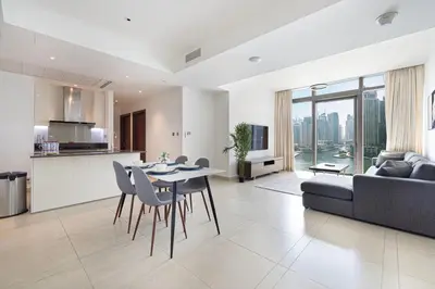a kitchen and living room with a table and a couch at 3BR Full Marina View for 8 Near The Metro! in Dubai