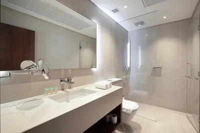a bathroom with a sink and a toilet and a mirror at 3BR Full Marina View for 8 Near The Metro! in Dubai