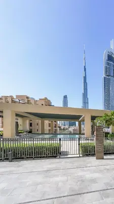 a large building with a fence and some buildings at Elegant 2BR in Burj Royale in Dubai