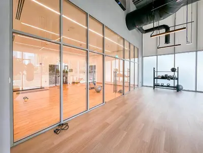 an empty room with a gym with glass walls at Luxury 3BR and Maid room Forte Tower 1 with Fountain View in Dubai