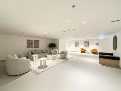 a living room with couches and tables and chairs at Luxury 3BR and Maid room Forte Tower 1 with Fountain View in Dubai