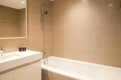 a bathroom with a tub and a sink and a shower at Stunning 2BR Apt Burj Royale 10 mins walk to Dubai mall in Dubai