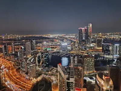 a view of a city at night with traffic at Stunning 2BR Apt Burj Royale 10 mins walk to Dubai mall in Dubai