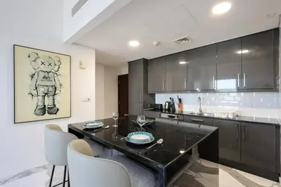 a kitchen with a table and chairs in a room at Upgraded 1B with Beach Access and Ain Dubai Views in Dubai