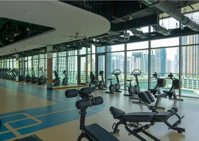 a gym with a lot of exercise equipment in a building at Cosy Apartment Marina Gate in Dubai