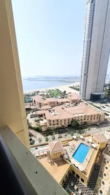 a view of a resort with a swimming pool at Breathtaking Sea and Palm View Spacious Studio with Vibrant Vibes in JBR By SWEET HOMES in Dubai
