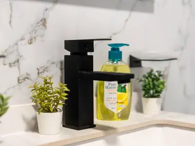 a bathroom sink with a bottle of detergent at Spacious Home in the heart of Marina w Seaview in Dubai
