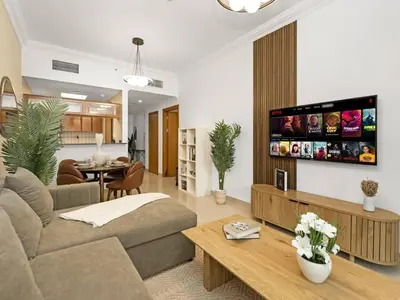 a living room with a couch and a table at Spacious Home in the heart of Marina w Seaview in Dubai