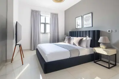 a bedroom with a large bed and a window at Frank Porter - Dezire Residences in Dubai