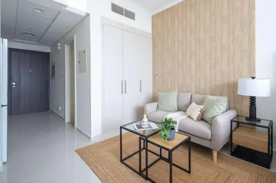 a living room with a couch and a table at Frank Porter - Damac Carson B in Dubai