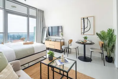 a hotel room with a bed and a table and chairs at Frank Porter - Damac Carson B in Dubai
