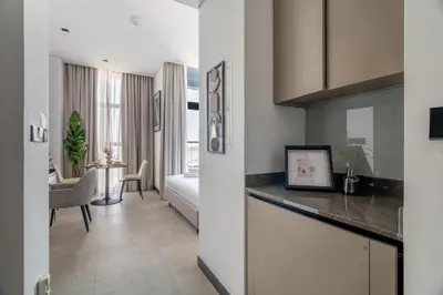 a kitchen and a living room with a table at GuestReady - Urban retreat at 15 Northside in Dubai