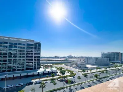an aerial view of a large building with a parking lot at Luxury Living in Azizi Riviera & Cozy Balcony in Dubai