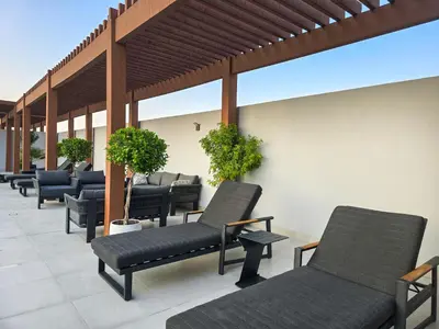 a row of chairs sitting on a patio at EasyGo - Modern STU- Luma22- JVC in Dubai