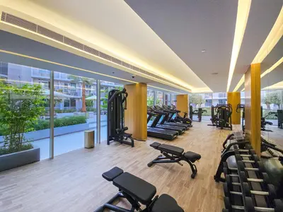 a gym with rows of exercise equipment in a building at EasyGo - Modern STU- Luma22- JVC in Dubai