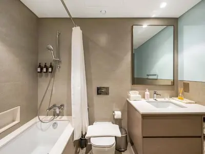 a bathroom with a tub and a toilet and a sink at Premium 1 BDR, In Burj Khalifa Park, Dubai Mall Walking Distance , Opera House 1mn away in Dubai