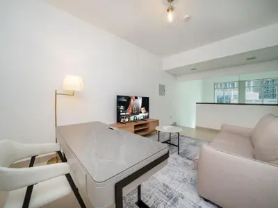 a living room with a couch and a table at Elegant 2 Bed Downtown Duplex - Prime Location in Dubai