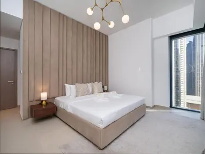 a bedroom with a large bed and a large window at Luxury Downtown 3 Bed with Full Burj Khalifa Views in Dubai
