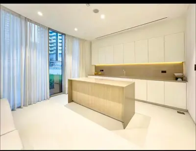 a kitchen with white cabinets and a large window at New 2 Bedroom apartment overlooking Burj Khalifa and fountain view in downtown in Dubai