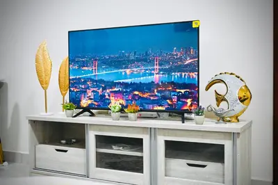 a television on a stand in a living room at Marina Breeze Residence Near to Yachts and Beach in Dubai