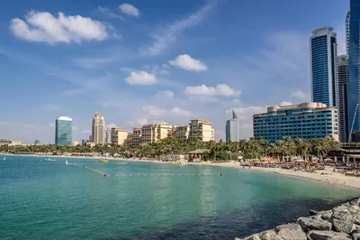 a beach in front of a city with tall buildings at Marina Breeze Residence Near to Yachts and Beach in Dubai
