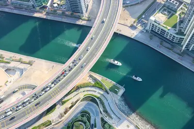 an overhead view of a bridge over a river with traffic at Stunning 1BR with Marina View And Beach Access in Dubai