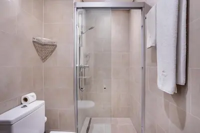 a bathroom with a glass shower with a toilet at STAY BY LATINEM Luxury 1BR Holiday Home CV B207 near Burj Khalifa in Dubai