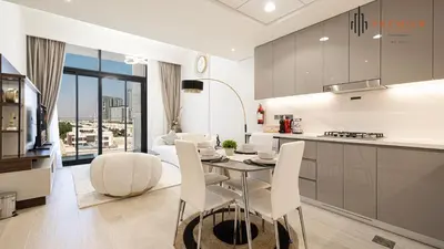 a kitchen and living room with a table and chairs at PREMIER 1BR - Burj Khalifa View in Dubai