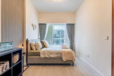 a bedroom with a bed and a large window at Elegant 2 Bedroom in Business Bay with Burj View in Dubai