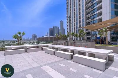 a group of benches in a city with buildings at Vogue Downtown Views II with Direct Access to Dubai Mall Via a Climate Controlled Bridge, One Bedroom Apartment with Balcony and City View in Dubai