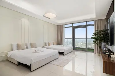 a bedroom with two beds and a large window at Paramount Midtown by Luxe Living in Dubai