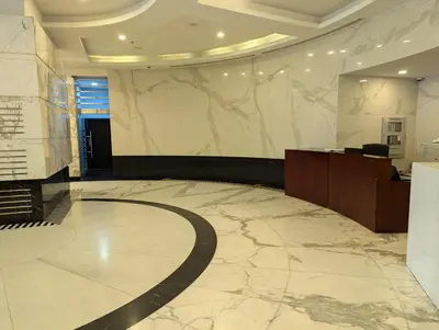 a large lobby with a marble floor and a desk at Stunning 2BR Apartment with Full Marina View in Dubai