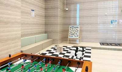 a room with a chessboard and a room with a table at Canal-View Duplex in Dubai