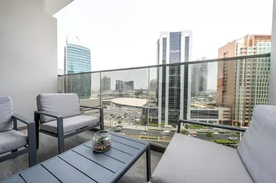 a balcony with chairs and a table and a view of a city at Wohnung im Stadtzentrum von Dubai in Dubai