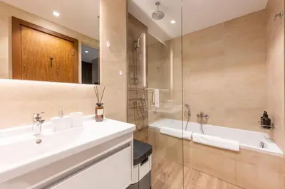 a bathroom with a sink and a shower and a tub at Exclusive Marina Stay - Posh 3BR with Stunning Views in Dubai