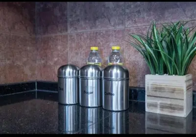 three bottles of water sitting on a table with a plant at Hamilton Residence - Luxury 1BR - Stunning Dubai Canal View - Near Dubai Mall & Burj Khalifa in Dubai