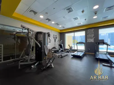 a gym with treadmills and ellipticals in a building at Hamilton Residence - Luxury 1BR - Stunning Dubai Canal View - Near Dubai Mall & Burj Khalifa in Dubai