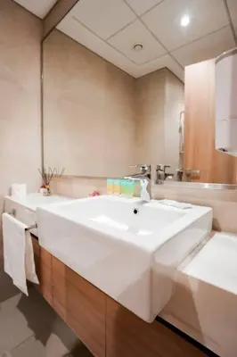 a bathroom with a white sink and a mirror at Cozy Studio with Garden Views in Nad Al Sheba in Dubai