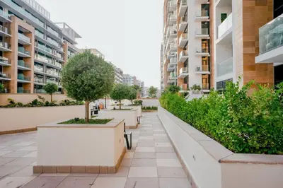 a walkway in a city with buildings at Cozy Studio with Garden Views in Nad Al Sheba in Dubai