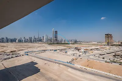 a construction site with a city in the background at Cozy Studio in Azizi Riviera 3, Al Merkadh by Deluxe Holiday Homes in Dubai