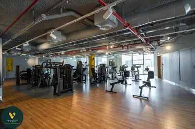 a gym with several treadmills and elliptical machines at Vogue Downtown Views II with Direct Access to Dubai Mall Via a Climate Controlled Bridge, Two Bedroom Apartment with Balcony and Burj Khalifa View in Dubai